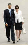 President Barack Obama leaves the town hall meeting with Senior Adviser Valerie Jarrett.