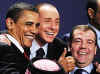 President Obama gestures during the group photo with Russian President Medvedev and Italian Prime Minister Berlusconi.