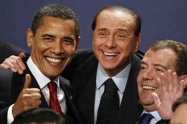 President Obama gestures during the G20 group photo with Russian President Medvedev and Italian Prime Minister Berlusconi.