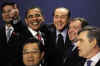 President Obama gestures during the group photo with Russian President Medvedev and Italian Prime Minister Berlusconi.