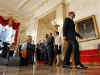 President Barack Obama leaves after speaking on the auto industry in the Grand Foyer of the White House on April 30, 2009.