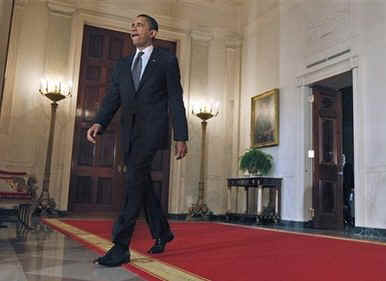 President Barack Obama arrives to speak on the auto industry in the Grand Foyer of the White House on April 30, 2009.