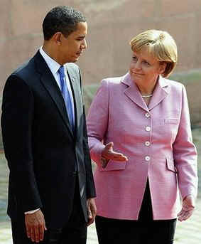 President Barack Obama joins German Chancellor Angela Merkel to inspect a German Military Honour Guard.
