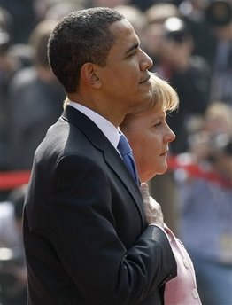 President Barack Obama and German Chancellor Angela Merkel pause for the national anthems of the US and Germany