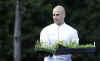 Assistant White House Chef SamKass carries out the herb seedlings.