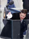 US Secret Service agent cleans the glass at podium at the Capitol Building in preparation for Obama's inauguration.