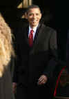 Barack Obama winks as he leaves Blair House for limousine to St. John's Episcopal Church across from the White House.