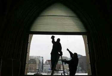 Cleaners wash the bullet proof glass installed in select Parliament Hill windows for Obama's Canadian visit.
