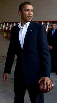 Obama holds a football after meeting with Steelers coach Tomlin while on the campaign trail in August 2008.