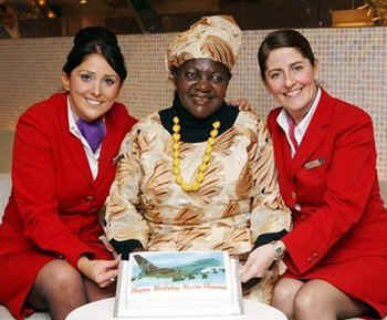 Barack Obama's stepmother Kezia Obama arrives at Heathrow Airport in London enroute to Obama's Inauguration. Kezia receives a birthday cake from the Virgin Air staff.