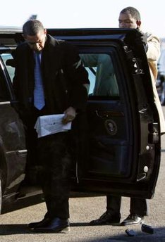 President-elect Barack Obama drops his Blackberry while getting out of his limousine on January 16, 2009.