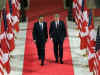 President Obama and PM Stephen Harper walk down the Hall of Honour on Parliament Hill on the way to a press conference.