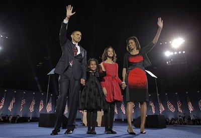 Barack, Sasha, Malia, and Michelle Obama wave to a cheering crowd. in Chicago on November 4, 2008.