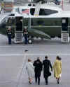 Barack and Michelle Obama escort George and Laura Bush to their waiting helicopter for a flight to Andrews Air Base.