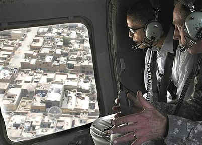 Barack Obama travels by helicopter with General David Petraeus after landing at Baghdad International Airport.