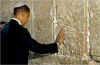 Obama prays and places a message in the cracks of the stone blocks of Jerusalem's West Wall on July 24, 2008.