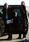 Barack Obama drops his Blackberry after getting out of his car at Reagan Airport in Washington. A Secret Service agent retrieves the device