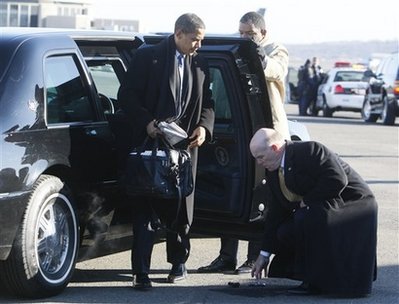 Barack Obama drops his Blackberry after getting out of his car at Reagan Airport in Washington. A Secret Service agent retrieves the device.