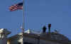 Secret Service agents watch from the top of the Eisenhower Executive Office Building in Washington.