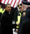Obama shakes the hand of a police officer during stop in Wilmington. Barack Obama meets Joe Biden in Wilmington, Delaware and delivers a brief speech. Barack Obama travels with Michelle Obama and Joseph and Jill Biden enroute from Philadelphia to Washington in a 137 mile whistle-stop tour imitating Abraham Lincoln's train journey almost 150 years after Lincoln's inaugural journey. 