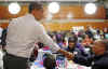 Barack Obama visits Calvin Coolidge High School in Washington where the students are working on projects which support US troops overseas. Barack Obama pays tribute to Martin Luther King Jr. by serving the community on Martin Luther King Day.