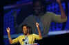 Michelle Obama pumps up the crowd at the Kids Inaugural: We Are The Future. Michelle attended with daughters Sasha and Malia and members of the Biden family. Barack and Michelle Obama do their pre-inauguration duties the day before Barack Obama's inauguration.