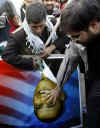 Students tear poster of Obama in Tehran, Iran on January 20, 2009.