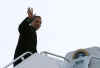 Barack Obama waves as he departs from Chicago Midway Airport for Washington via Andrews Air Force Base aboard a 757 military charter on January 4, 2009.