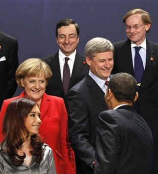 President Obama walked on the stage and walked directly to PM Harper to tease him about his absence from the original group photo.