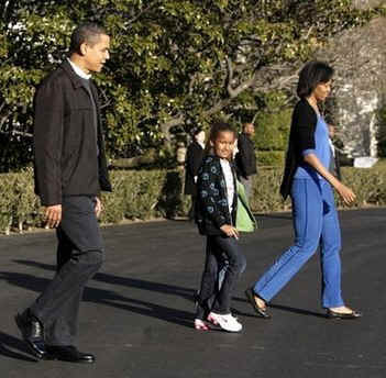 President Barack Obama and First Lady Michelle Obama walk from the White House across the South Lawn to board Marine One for an overnight stay at Camp David. Michelle Obama's mother and the Obama daughters and also flew to Camp David.