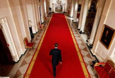 President Barack Obama walks down the Cross Hall of the White House after holding his first news conference as President in the East Room of the White House. The questions centered mostly on the President's economic stimulus package and the urgency of passing the financial bill.