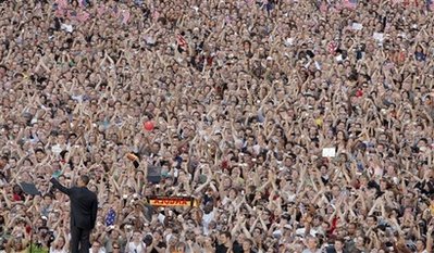 Barack Obama waves to a huge crowd on July, 24 2008 in Berlin Germany under Victory Column while on a European tour.