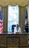President Obama on the phone in the Oval Office on the morning of his first day of work.