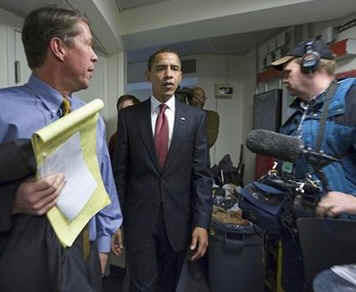 President Barack Obama makes a surprise visit to the crowded Brady Press Briefing Room at the White House.