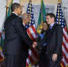 President Barack Obama attends the swearing in of Treasury Secretary Timothy Geithner, performed by Vice President Joseph Biden, at the Treasury Department in Washington on January 26, 2009.