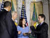 President Barack Obama attends the swearing in of Treasury Secretary Timothy Geithner, performed by Vice President Joseph Biden, at the Treasury Department in Washington on January 26, 2009.