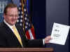 White House Press Secretary Robert Gibbs shows reporters document with the headlines of "Day 9" of Barack Obama's presidency.