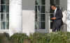 President Obama walks to the Oval Office holding his Blackberry which was recently altered for security reasons.