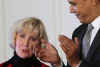 President Barack Obama signs his first bill into law as president in the East Room of the White House on January 29, 2009. President Obama signs the Lilly Ledbetter Fair Pay Act designed to eliminate pay inequities based on sex discrimination. Members of Congress. Hillary Clinton, and others join in witnessing the historic moment of Obama's signing of his first bill.