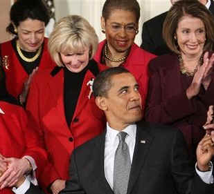 Watch the Official White House YouTube of Obama's Signing of the Lilly Ledbetter Fair Pay Act. Photo: President Barack Obama signs his first bill into law as president in the East Room of the White House on January 29, 2009. President Obama signs the Lilly Ledbetter Fair Pay Act designed to eliminate pay inequities based on sex discrimination. Members of Congress. Hillary Clinton, and others join in witnessing the historic moment of Obama's signing of his first bill.