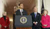 President Barack Obama signs his first bill into law as president in the East Room of the White House on January 29, 2009. President Obama signs the Lilly Ledbetter Fair Pay Act designed to eliminate pay inequities based on sex discrimination. Members of Congress. Hillary Clinton, and others join in witnessing the historic moment of Obama's signing of his first bill.