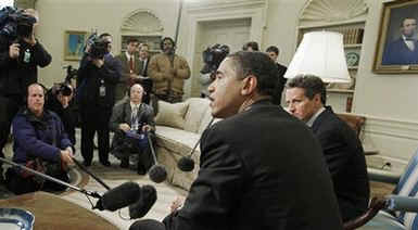 President Barack Obama meets with the press in the Oval Office of the White House. With Treasury Secretary Timothy Geithner at his side, Obama was visibly upset with Wall Street's recent multi-billion dollar bonuses to top executives. President Obama called Wall Street bonuses as "shameful" and irresponsible.