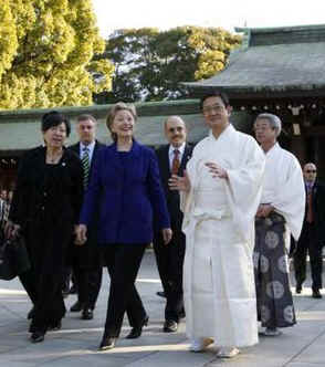 Secretary of State Hillary Clinton visits the Meiji Shrine in Tokyo. Temple priests guide Clinton through the shrine and prepare her for prayers and a sacred tree branch offering on February 17, 2009.