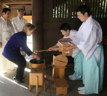 Secretary of State Hillary Clinton visits the Meiji Shrine in Tokyo. Temple priests guide Clinton through the shrine and prepare her for prayers and a sacred tree branch offering on February 17, 2009.
