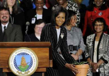 First Lady Michelle Obama visits the Department of Agriculture and thanks the department for their service. The First Lady presents Agriculture Secretary Tom Vilsack and the department staff a seedling (photo) from a White House magnolia tree.