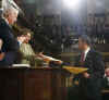 President Barack Obama submits copies of speech before he addresses the Joint Session of Congress at the Capitol in Washington on February 24, 2009.