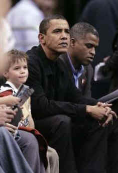 President Obama and his friend Marty Nesbitt watch the NBA match between the Washington Wizards and the Chicago Bulls at the Verizon Center in Washington. Obama is a Bulls fan, however the Wizards won the game 113-90.