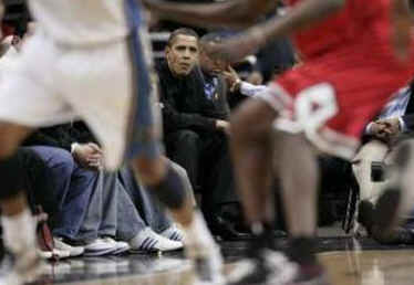 President Obama and his friend Marty Nesbitt watch the NBA match between the Washington Wizards and the Chicago Bulls at the Verizon Center in Washington. Obama is a Bulls fan, however the Wizards won the game 113-90.