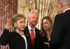 Hillary Clinton is officially sworn in as US Secretary of State by Vice President Joe Biden at the State Department in Washington on February 2, 2009. Guests for the ceremony included former Secretaries of State James Baker and Henry Kissinger. and celebrities like Chevy Chase. Daughter Chelsea and husband Bill Clinton joined the ceremony, with former President Bill Clinton holding the Bible for the swear-in.