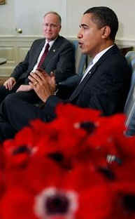 President Barack Obama talks to reporters in the Oval Office of the White House after discussions on his economic stimulus plan. Vermont Governor Jim Douglas sits with President Obama.